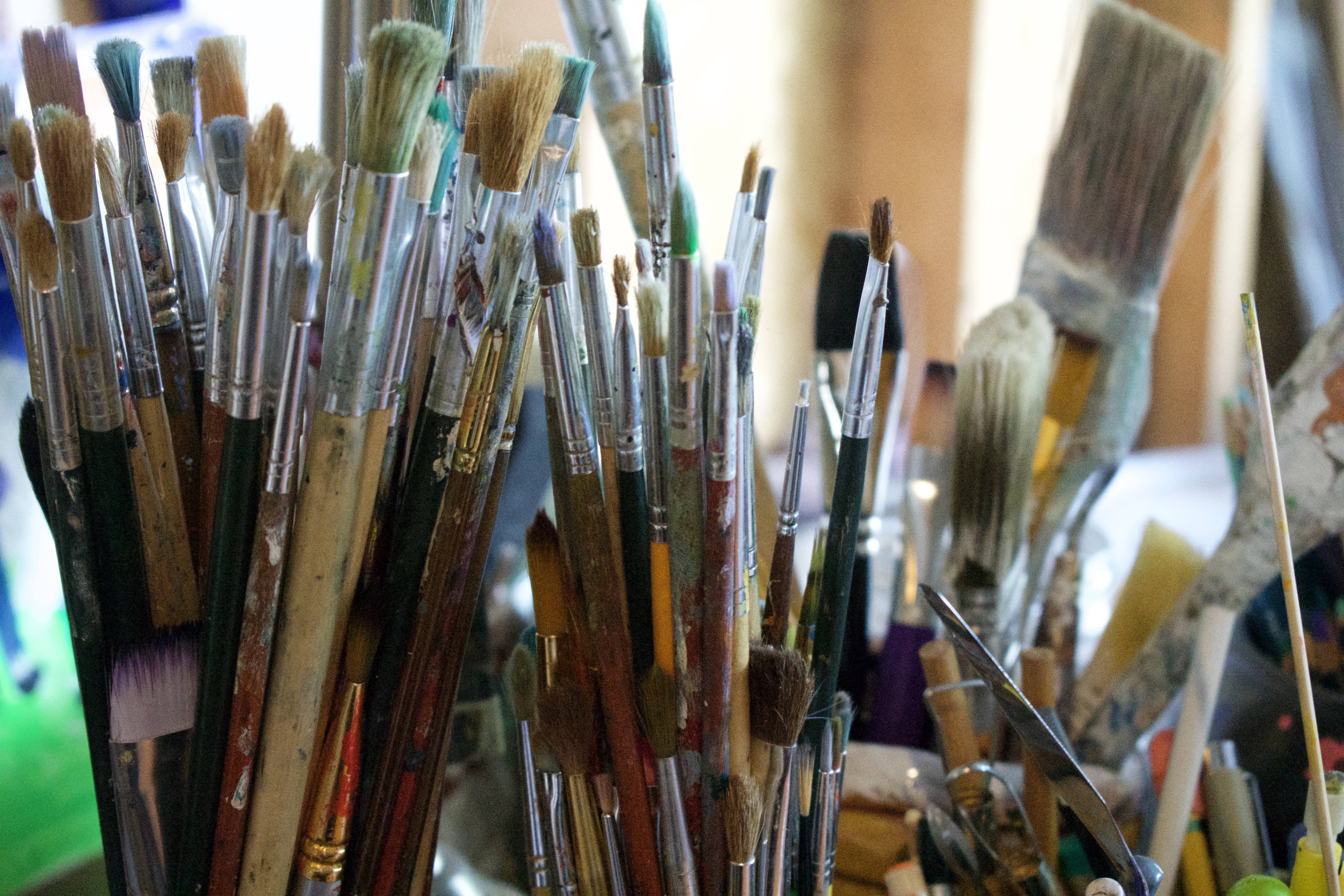 paintbrushes in glass jars
